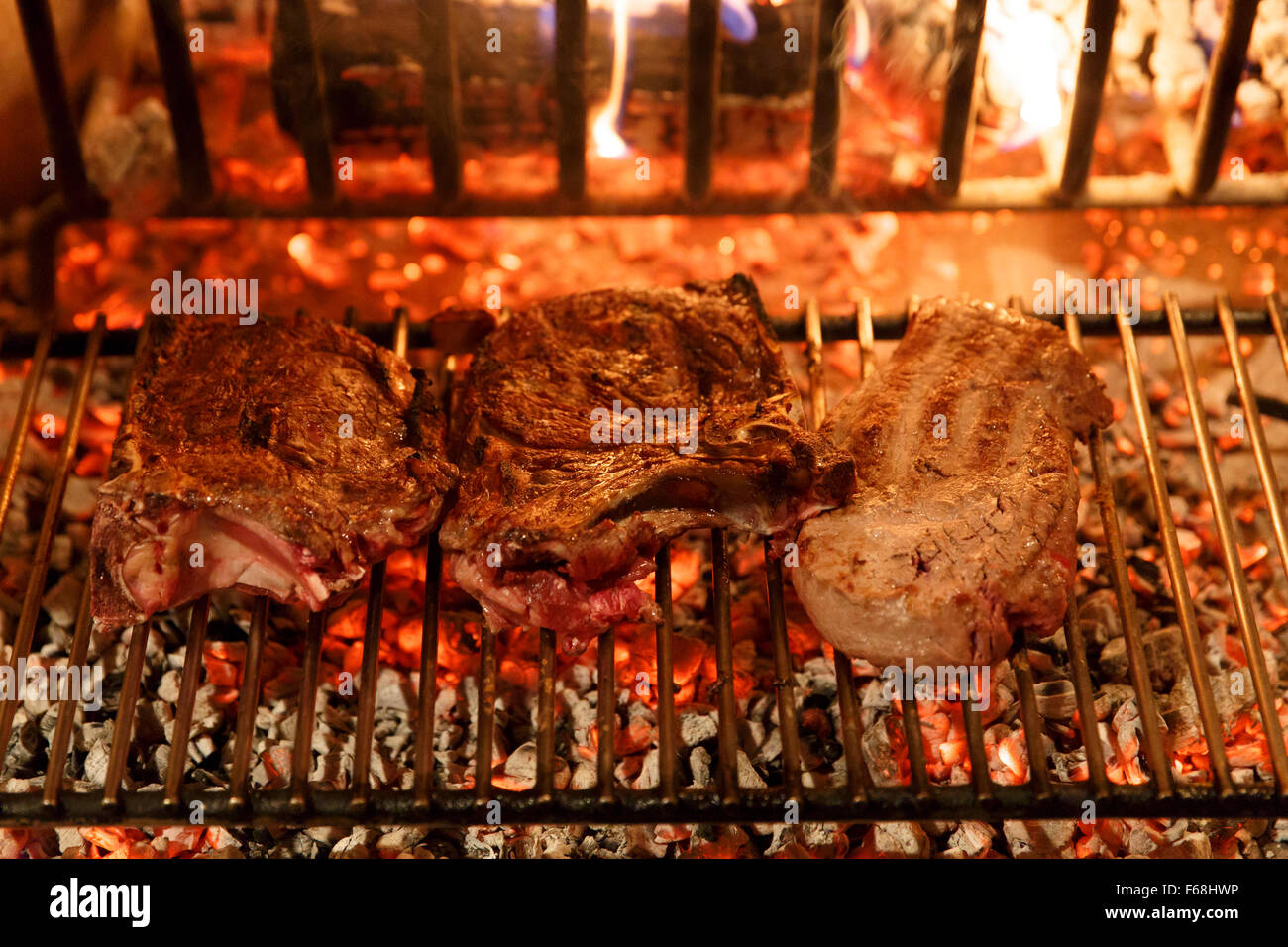 A top sirloin steak flame broiled on a barbecue, shallow depth of field