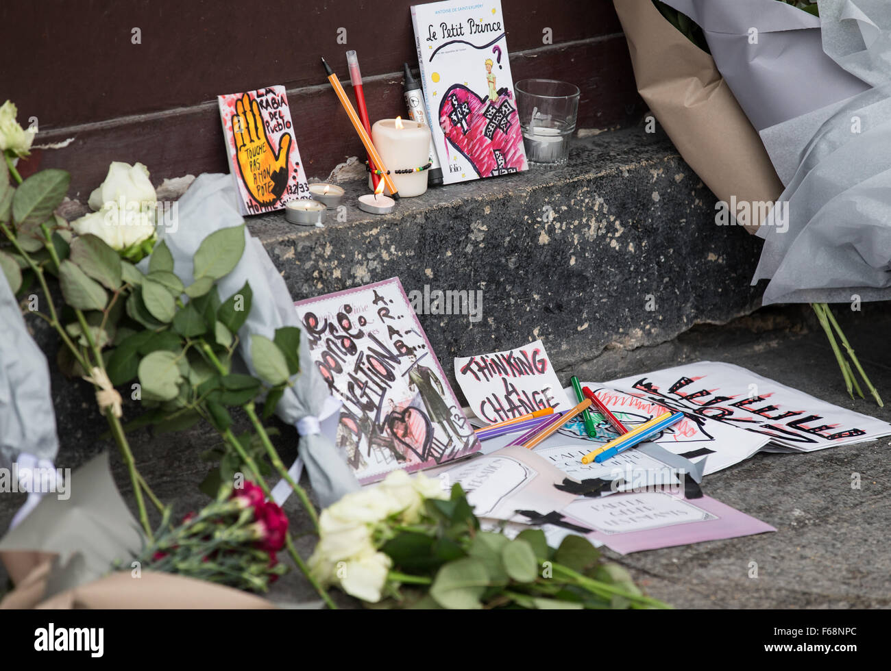 Paris, France. 14th Nov, 2015. Flowers and cards are placed in front of the Le Petit Cambodge Restaurant where an attack happend the other day in Paris, France, Nov. 14, 2015. French President Francois Hollande announced a three-days national mourning on Saturday. Credit:  Xu Jinquan/Xinhua/Alamy Live News Stock Photo