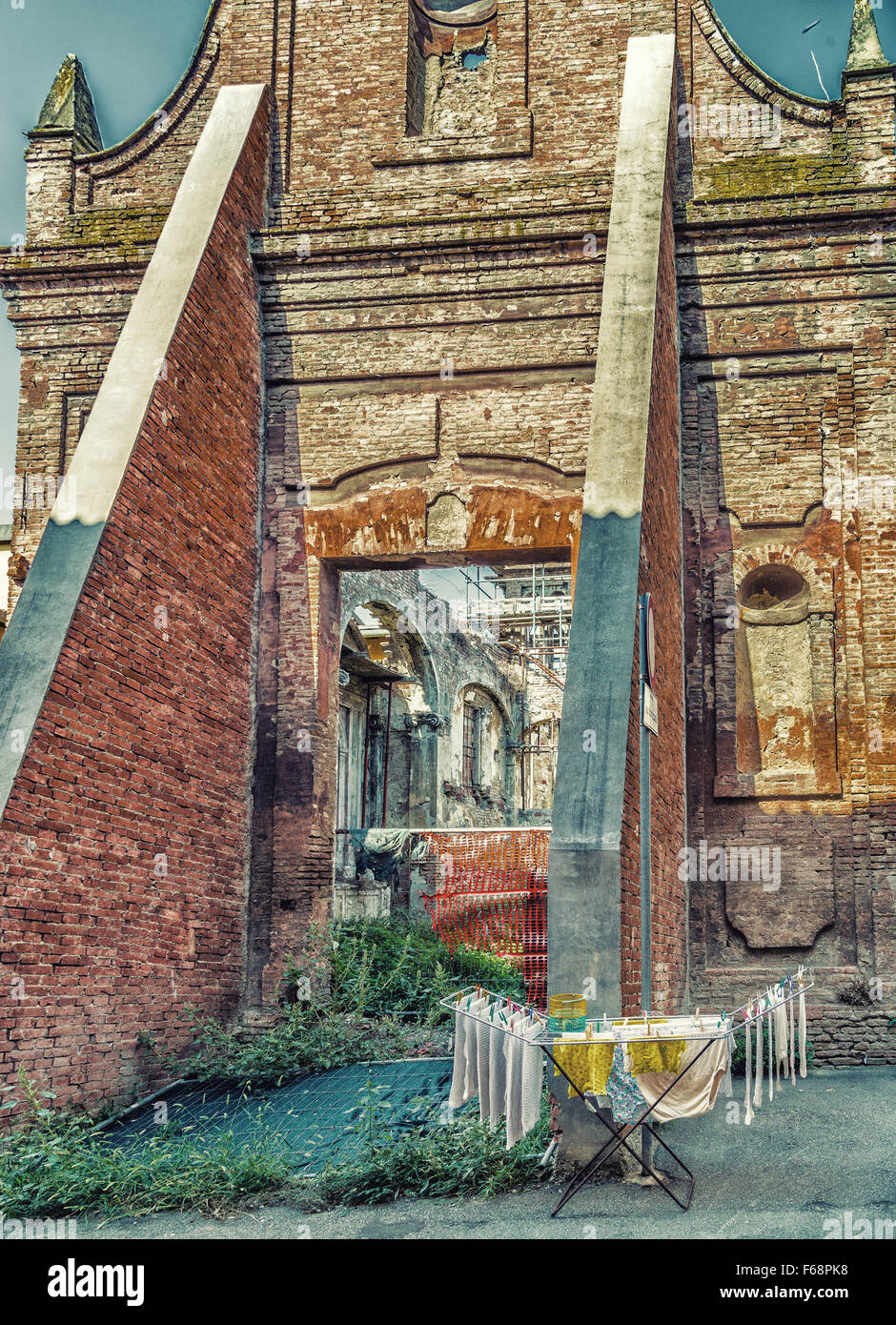 clothes hung out to dry on a drying rack in front of historic ruins in