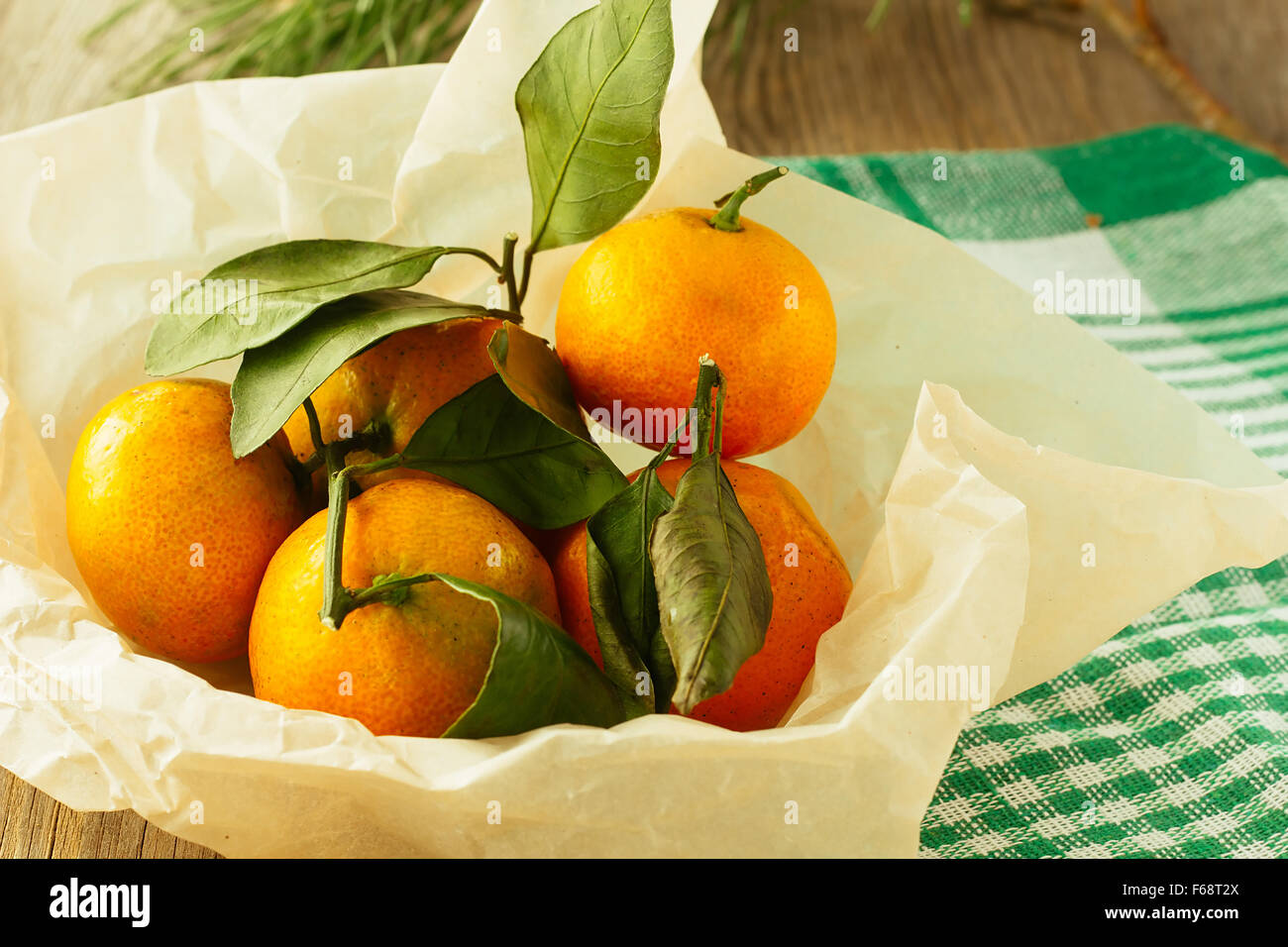 Tangerines in cooking paper horizontal selective focus Stock Photo