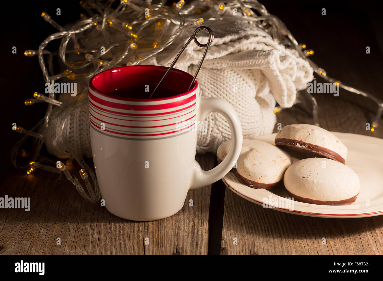 Cup of tea, pullover, gingerbread in a low key selective focus Stock Photo