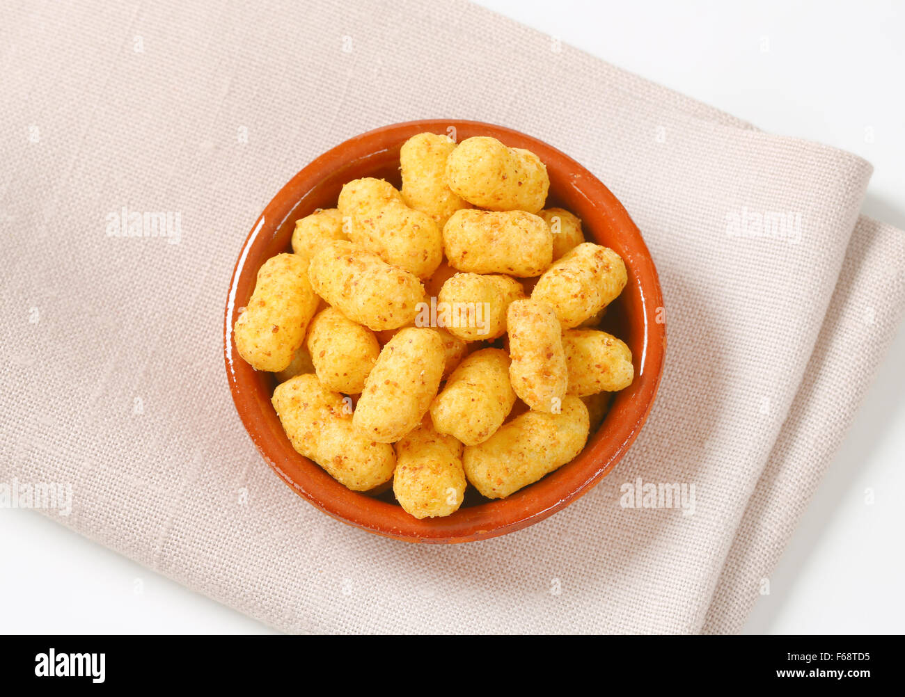 bowl of peanut crisps on folded place mat Stock Photo