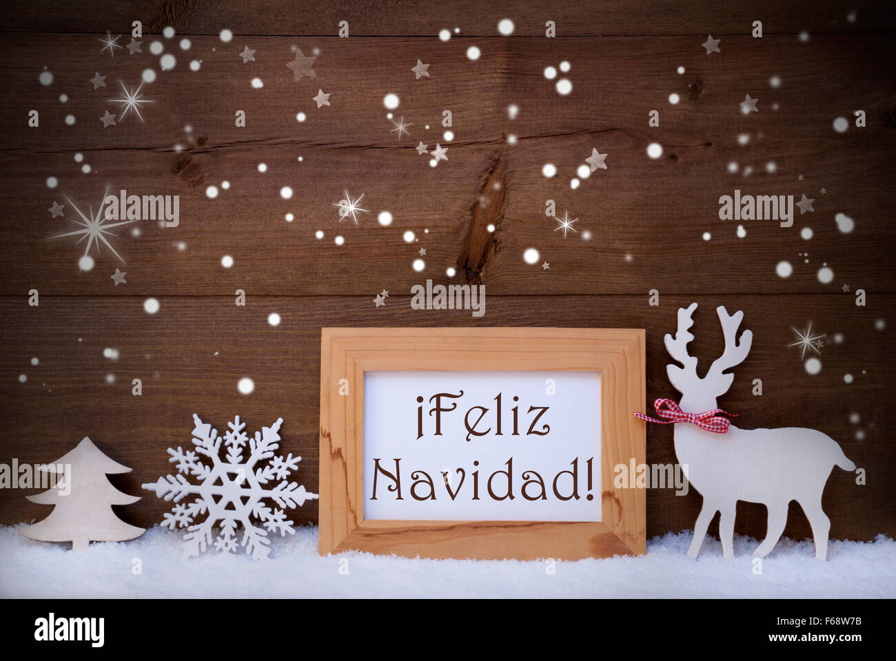 White Decoration On Snow, Feliz Navidad Means Merry Christmas Stock Photo