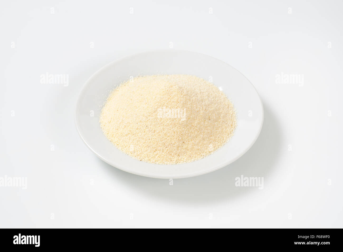plate of grits on white background Stock Photo