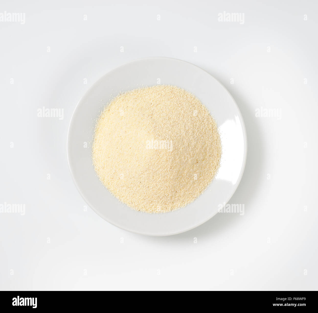 plate of grits on white background Stock Photo