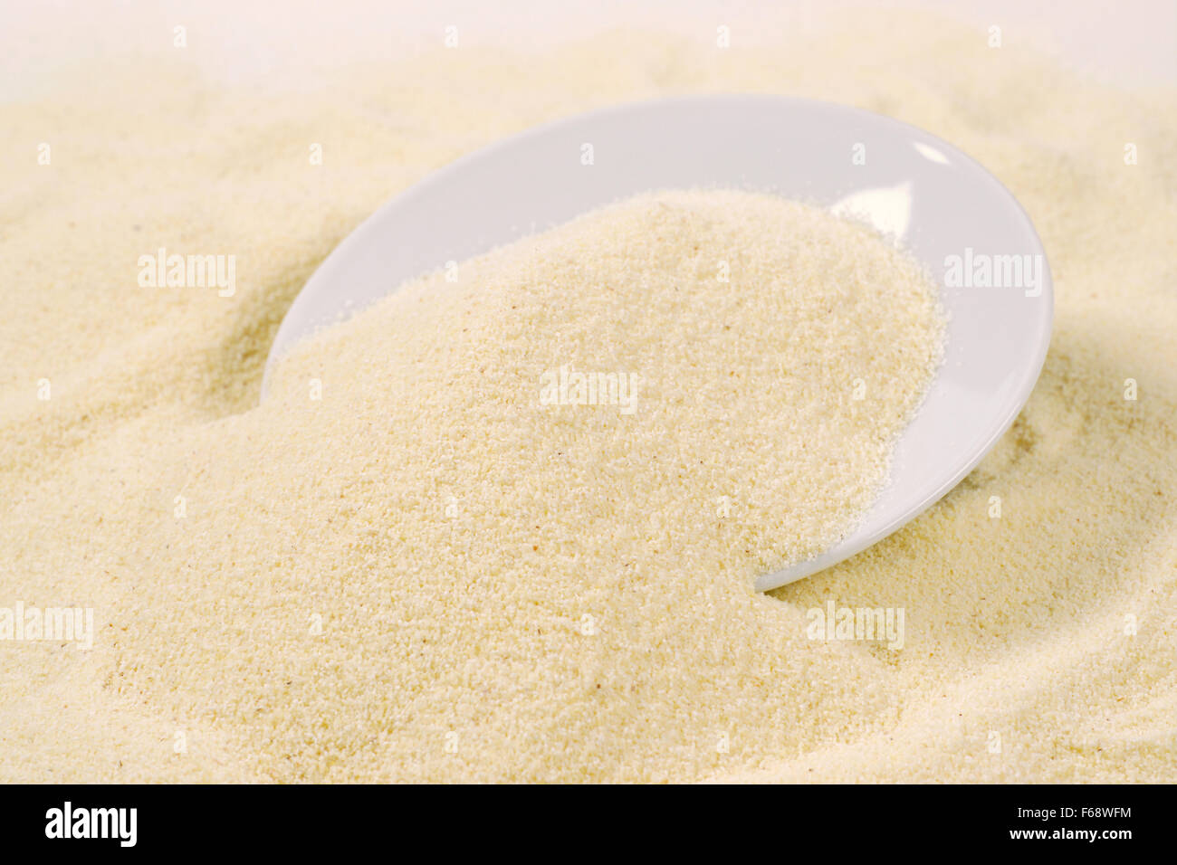 close up of grits spilling out of white plate Stock Photo