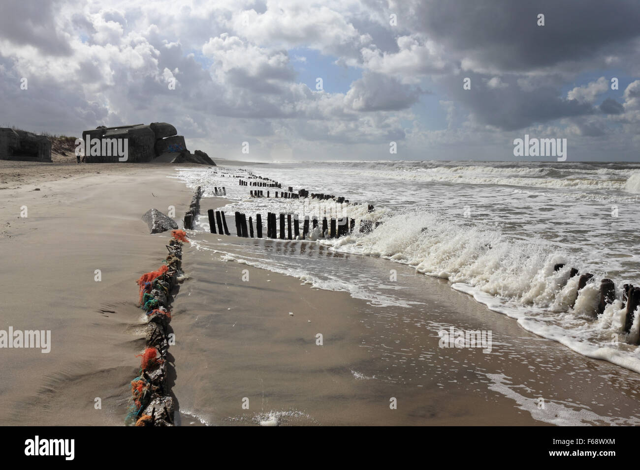 WW2 Nazi defence bunker and wooden stakes on the beach at Houvig Strand, Søndervig, Jutland, Denmark. Stock Photo