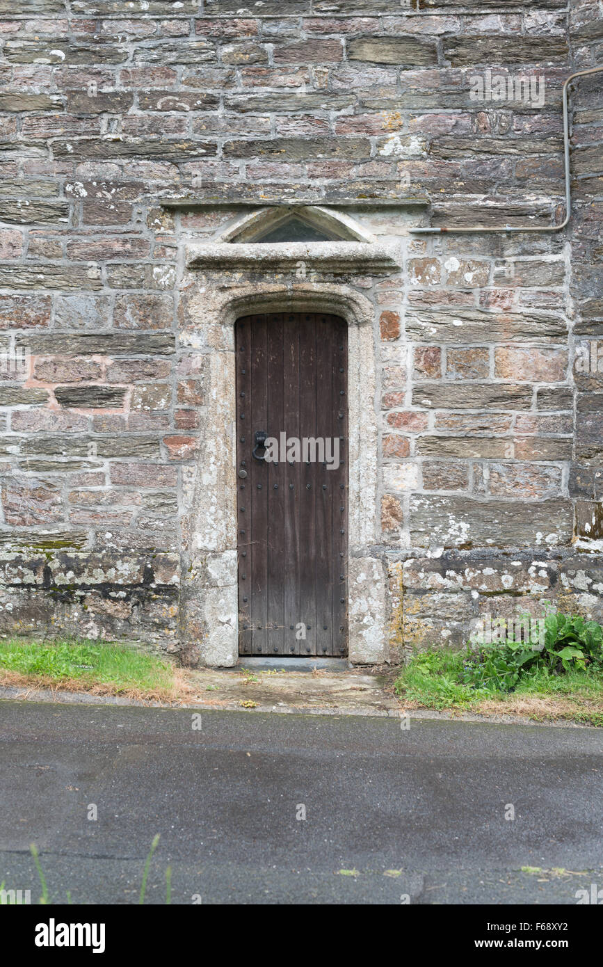 Narrow wooden door on side of St. George's Church, Modbury, Devon Stock ...
