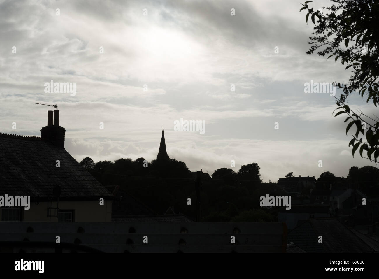 Silhouette of St. George's church and house roofs in Modbury, Devon ...