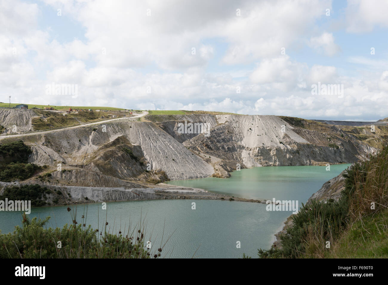 Spoil heaps alongside water filled china-clay pit on edge of Dartmoor Stock Photo