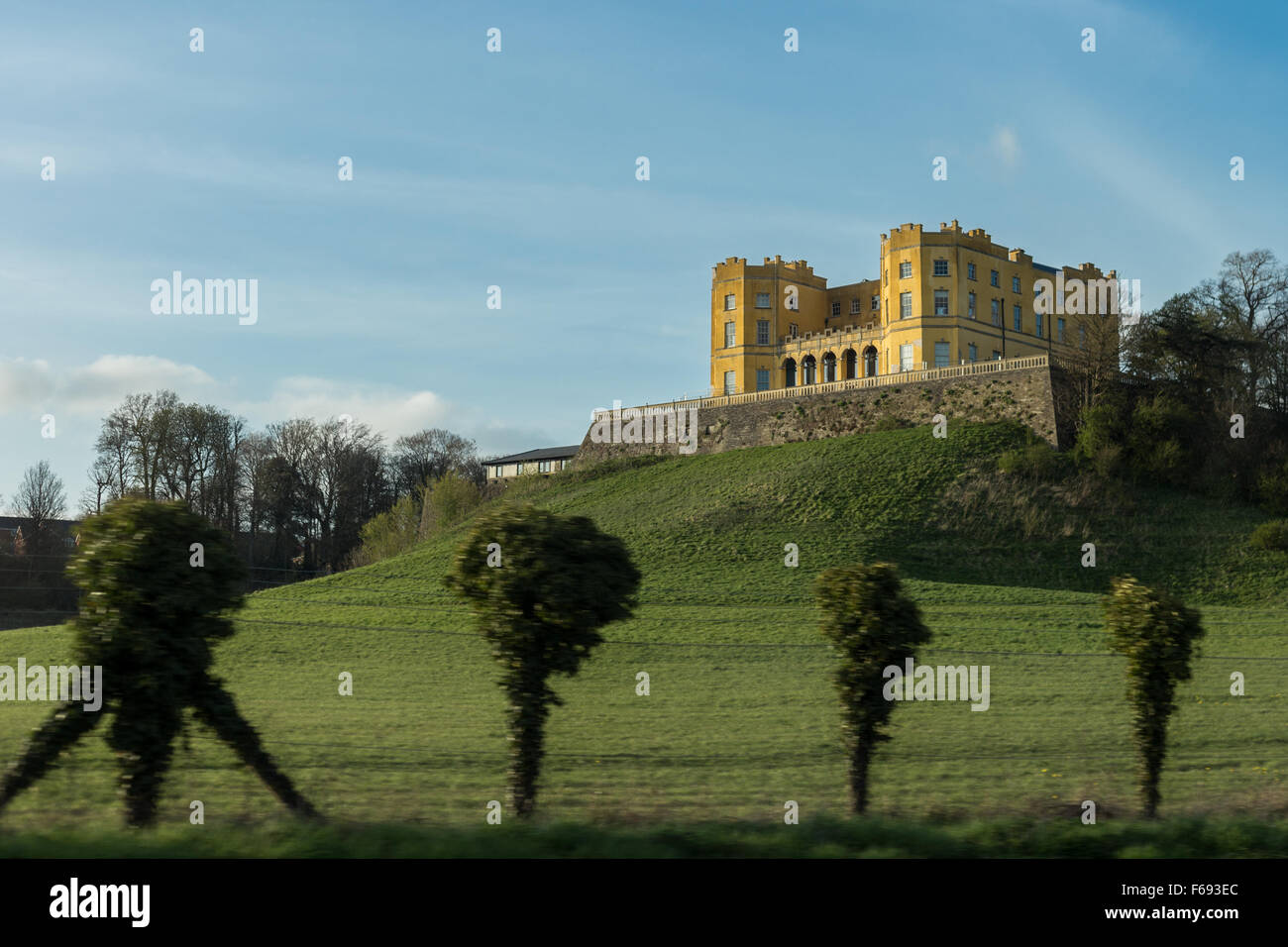 The yellow landmark building, The Dower House at Stoke Park alongside
