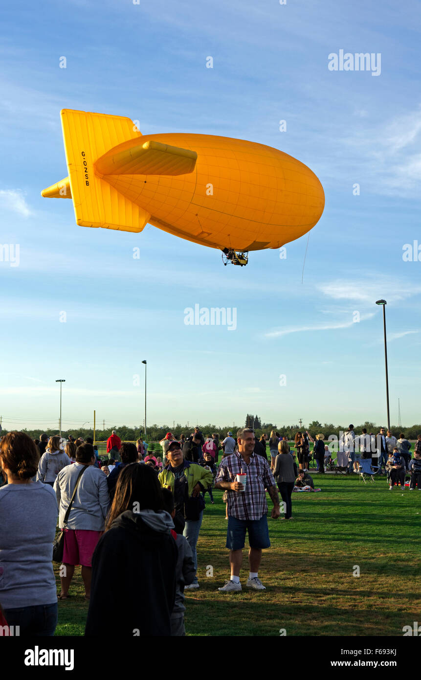 Air ship floats above the crowd on the field hires stock photography