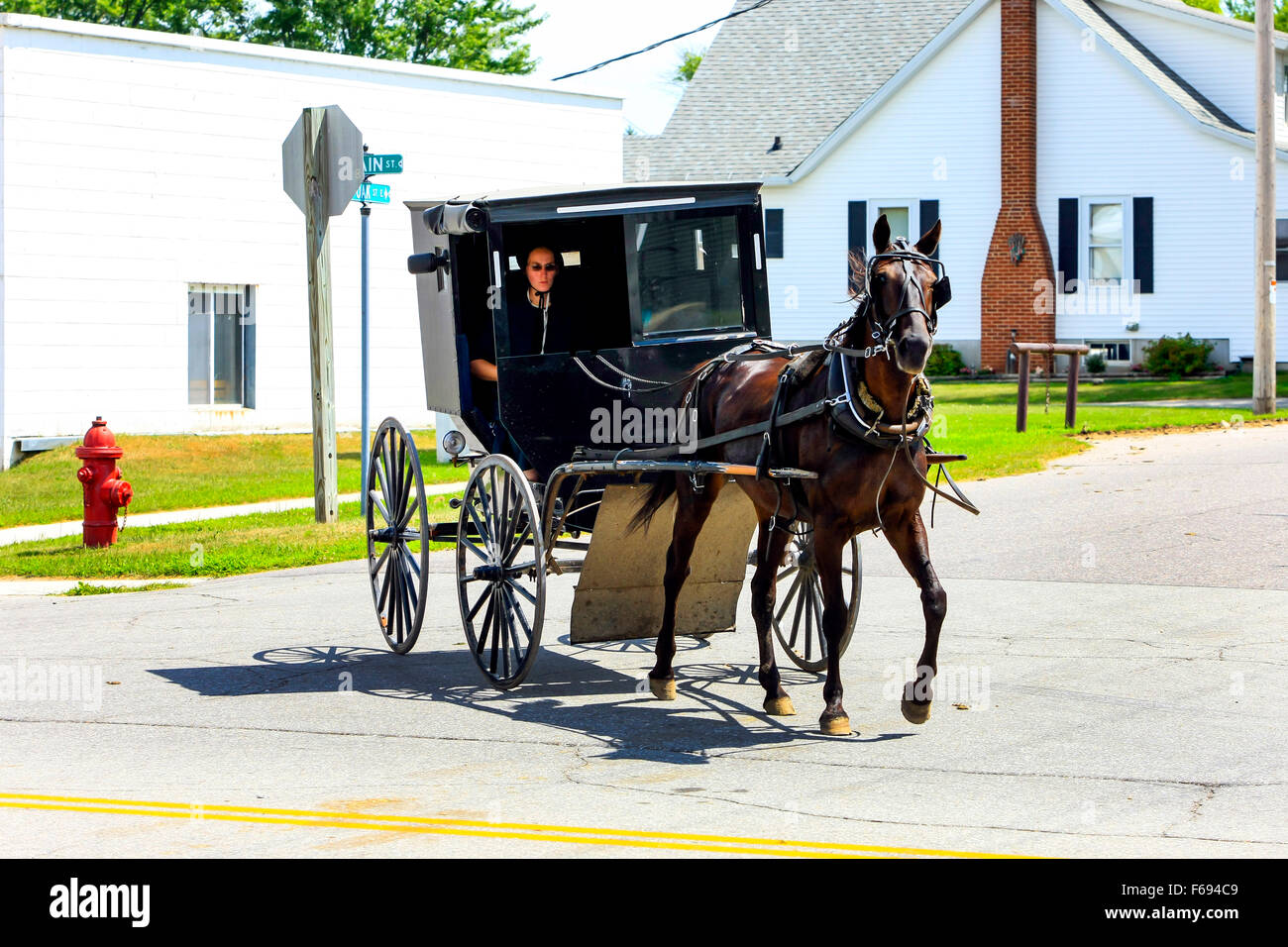 Amish horse and buggy on the road in a small rural community in