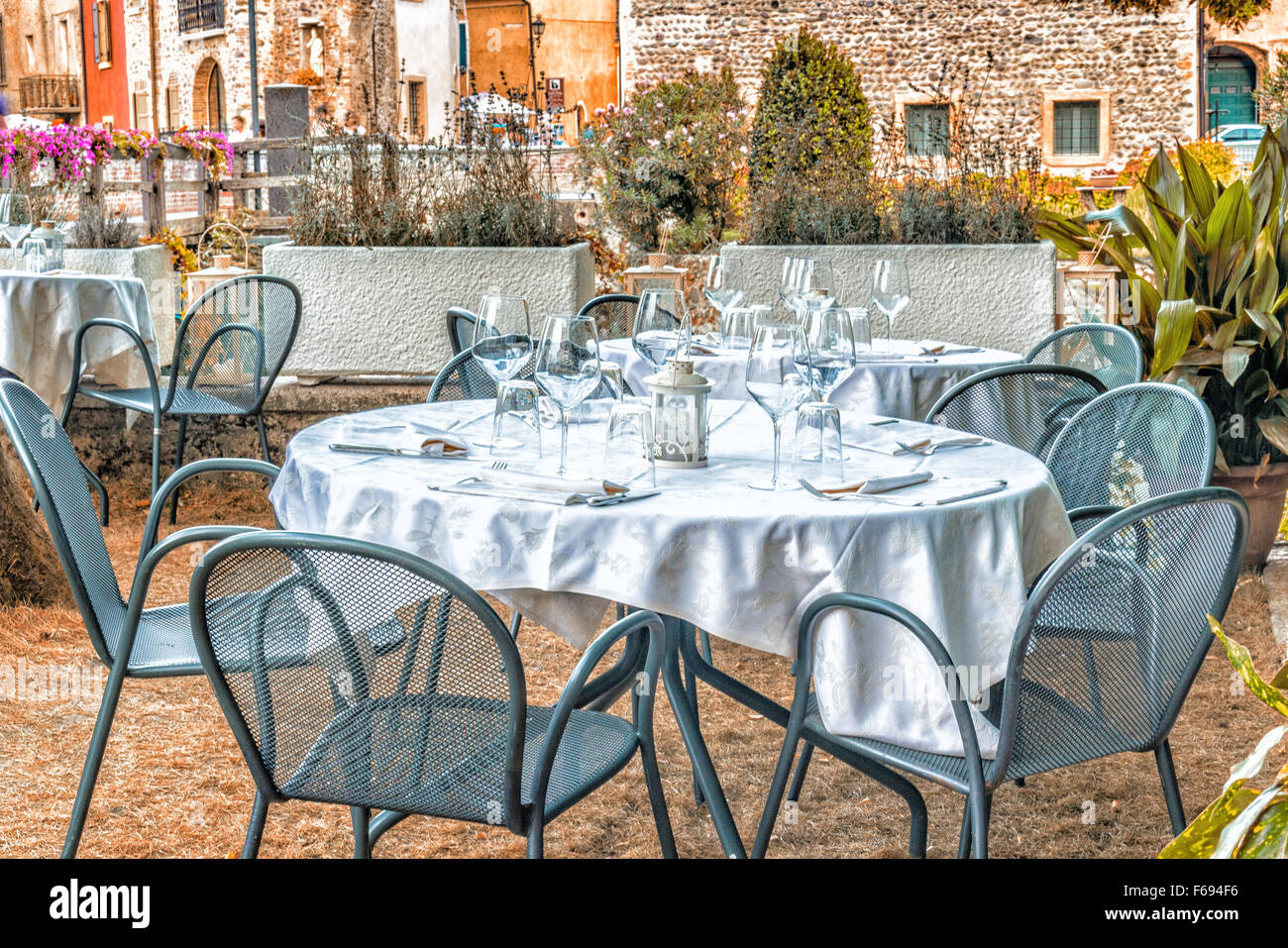 Luxury restaurant table with glasses, napkins and cutlery in a medieval town in the Italian countryside Stock Photo
