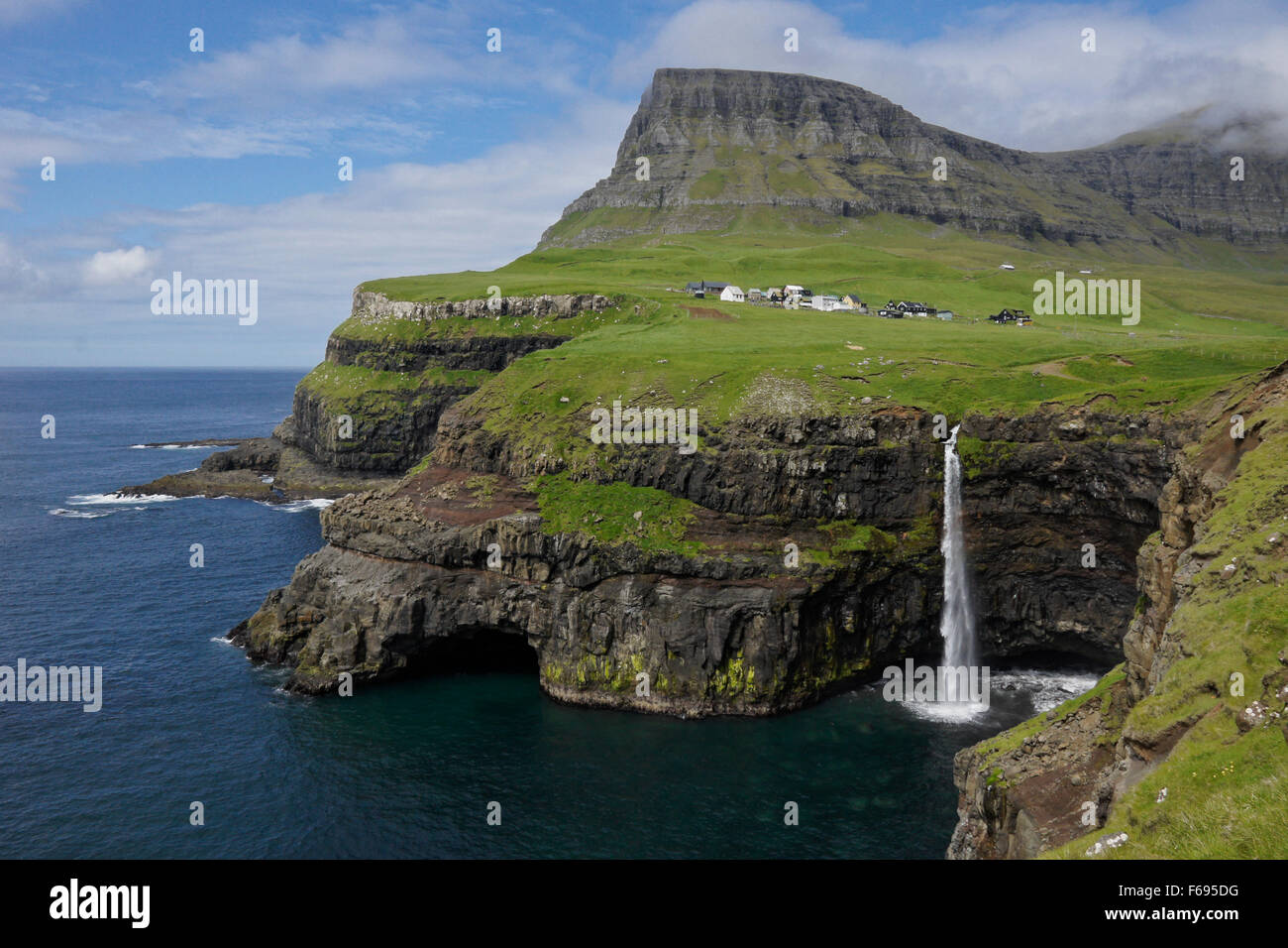 Mulafossur waterfall and village of Gasaladur, Vagar Island, Faroe Islands Stock Photo