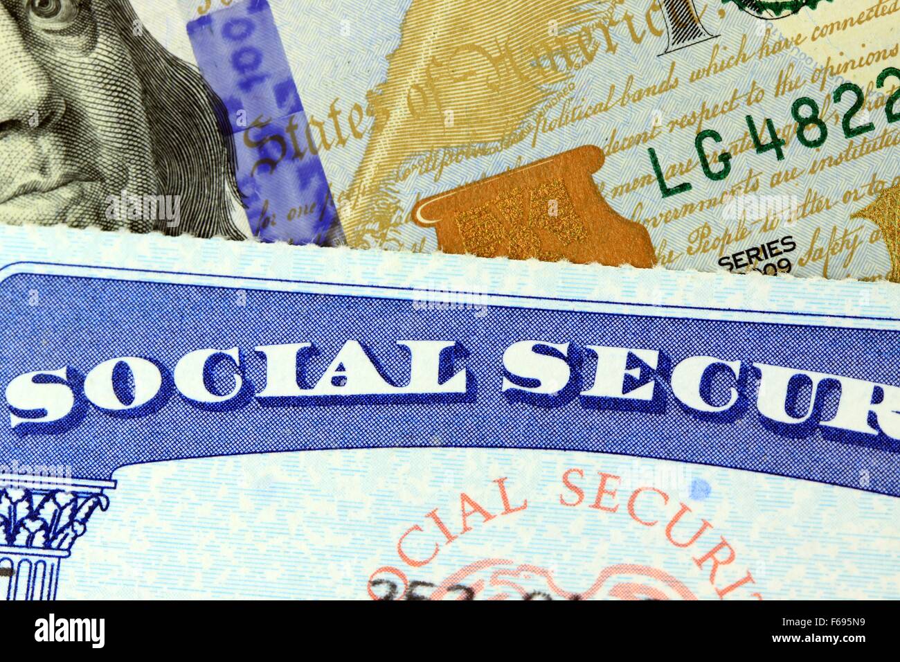 Social security card and US currency one hundred dollar bill Stock Photo