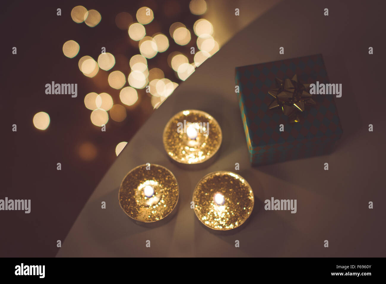Christmas gift and golden candles Stock Photo Alamy