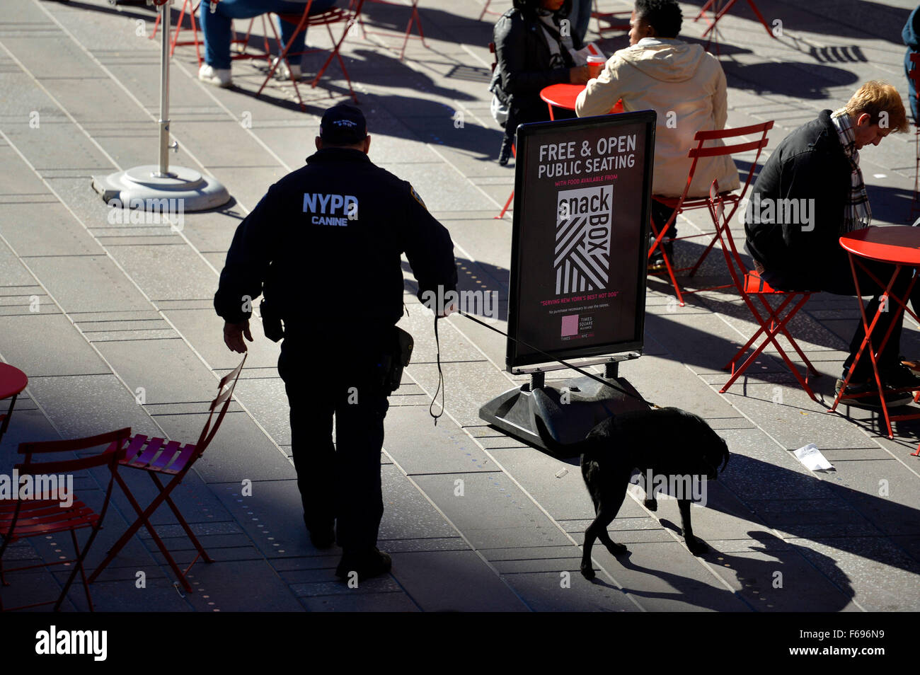 New York, USA. 14th Nov, 2015. A police officer patrols with a police dog in the Times Square in Manhattan, New York City, the United States, Nov. 14, 2015. The NYPD Counterterrorism Response Command (CRC), the Critical Response Group (SRG), and Operation Hercules Teams have been dispatched to crowded areas around the city as a precaution after the deadly series of attacks hit Paris on Friday night. © Wang Lei/Xinhua/Alamy Live News Stock Photo