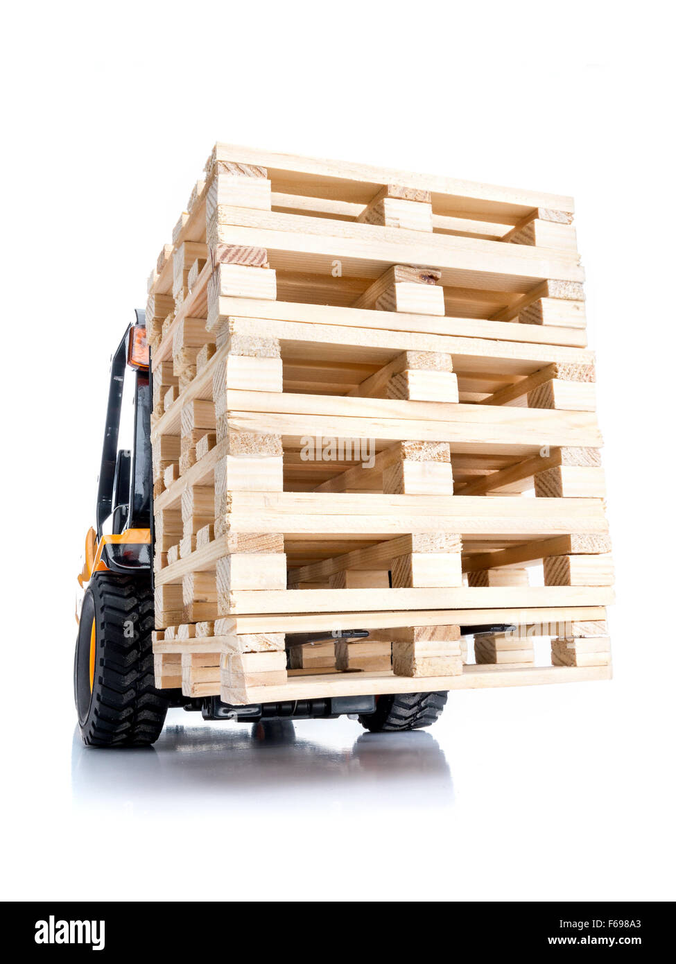 Forklift truck carrying stacked wooden pallets shot on white background Stock Photo