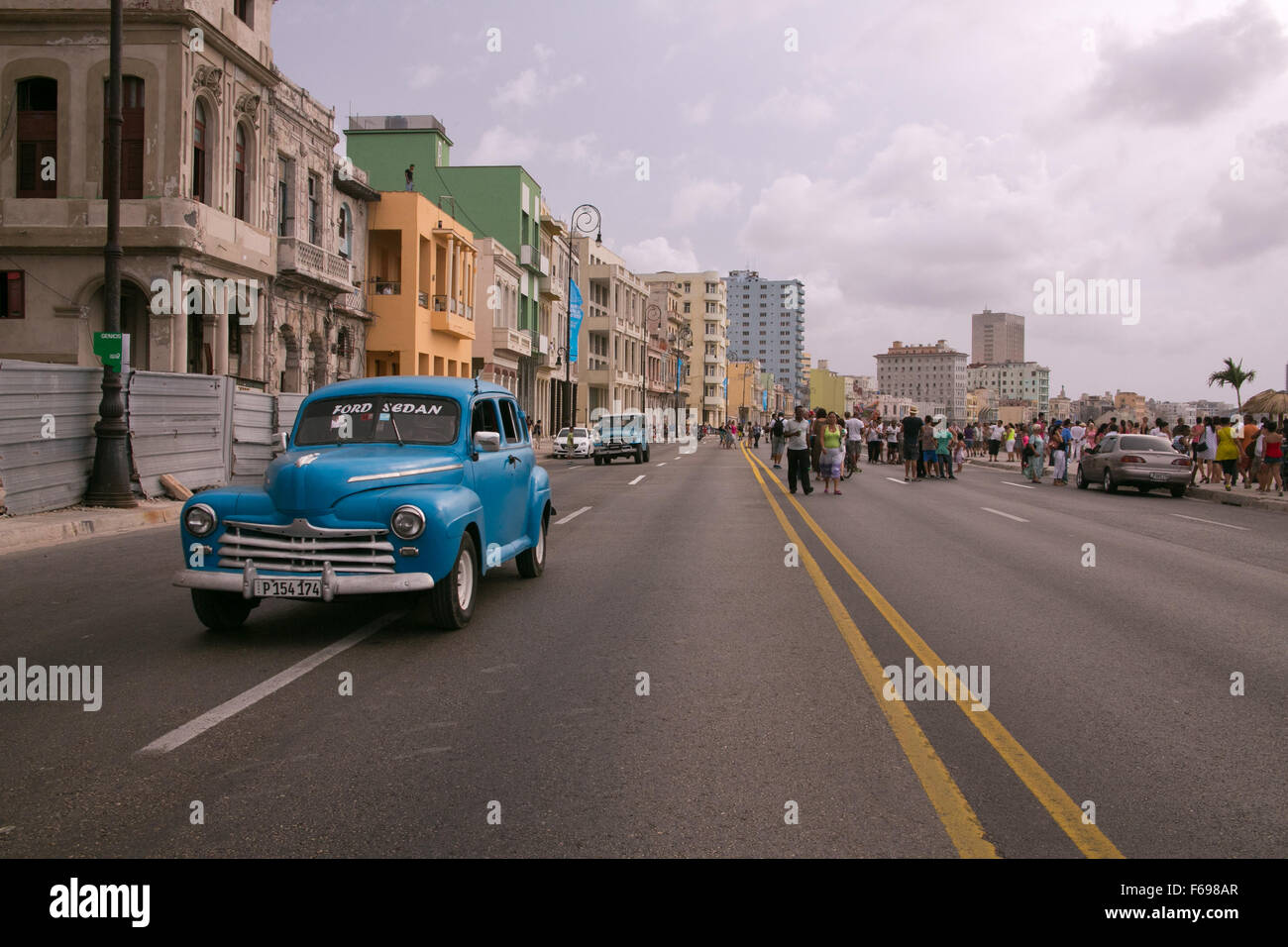 An old American classic driving along the Malecon in Havana, Cuba. Stock Photo