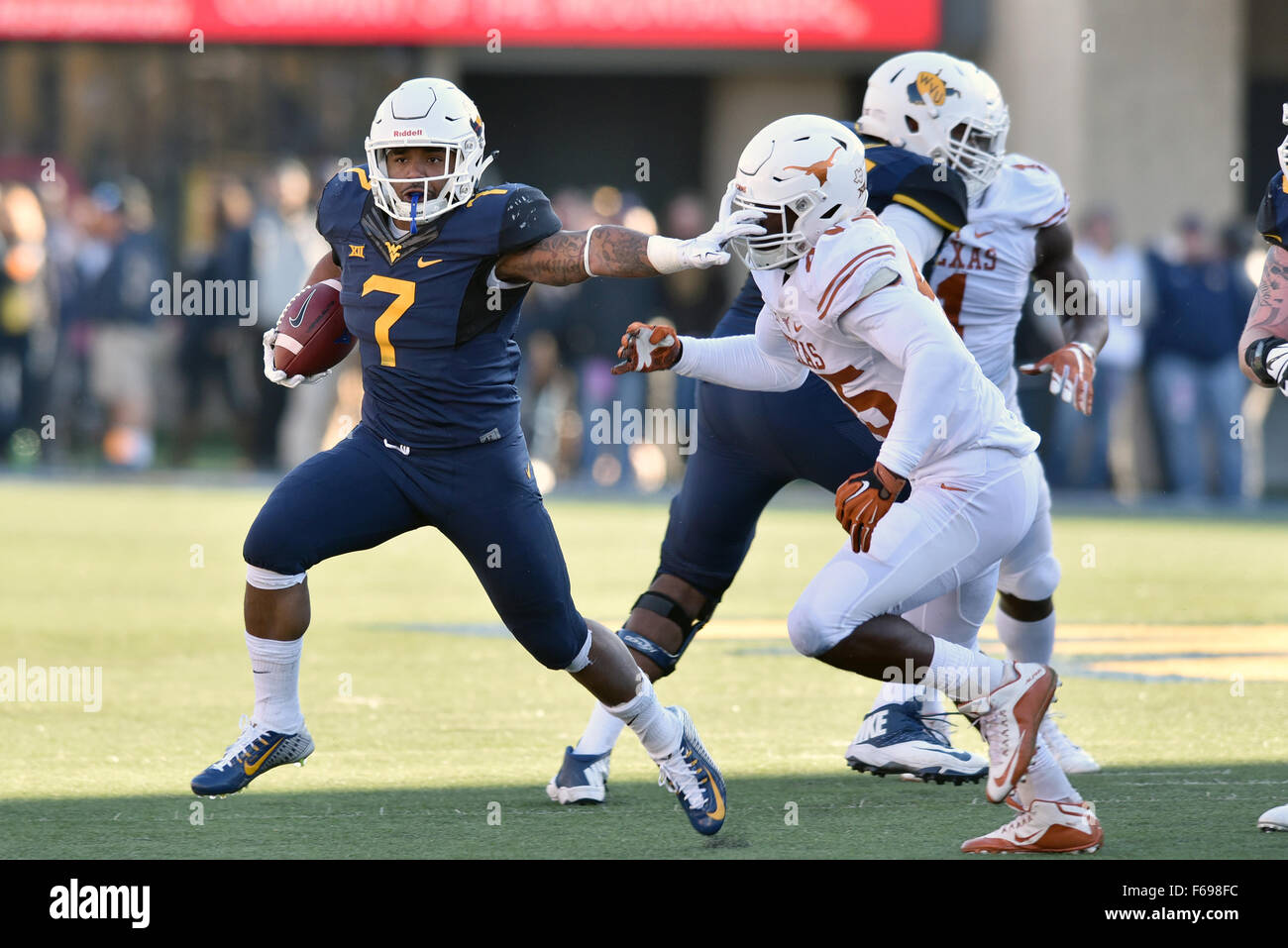 Morgantown, West VIrginia, USA. 14th Nov, 2015. West Virginia Mountaineers running back RUSHEL SHELL (7) stiff arms Texas Longhorns linebacker ANTHONY WHEELER (45) during a Big 12 conference football game played at Mountaineer Field at Milan Puskar Stadium in Morgantown, WV. WVU beat Texas 38-20. Credit:  Ken Inness/ZUMA Wire/Alamy Live News Stock Photo