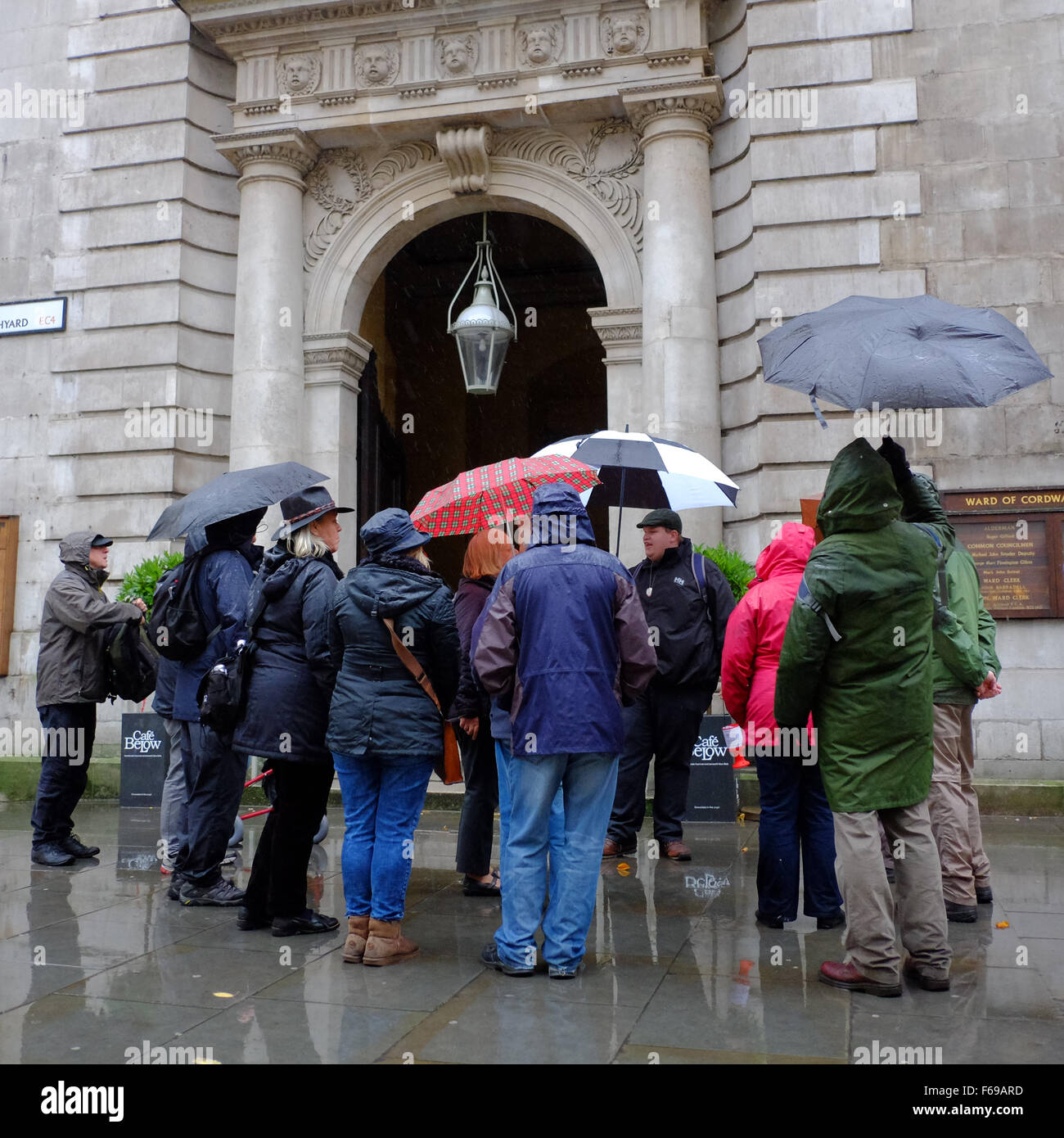Tour guide and tourists with umbrellas in London Stock Photo Alamy