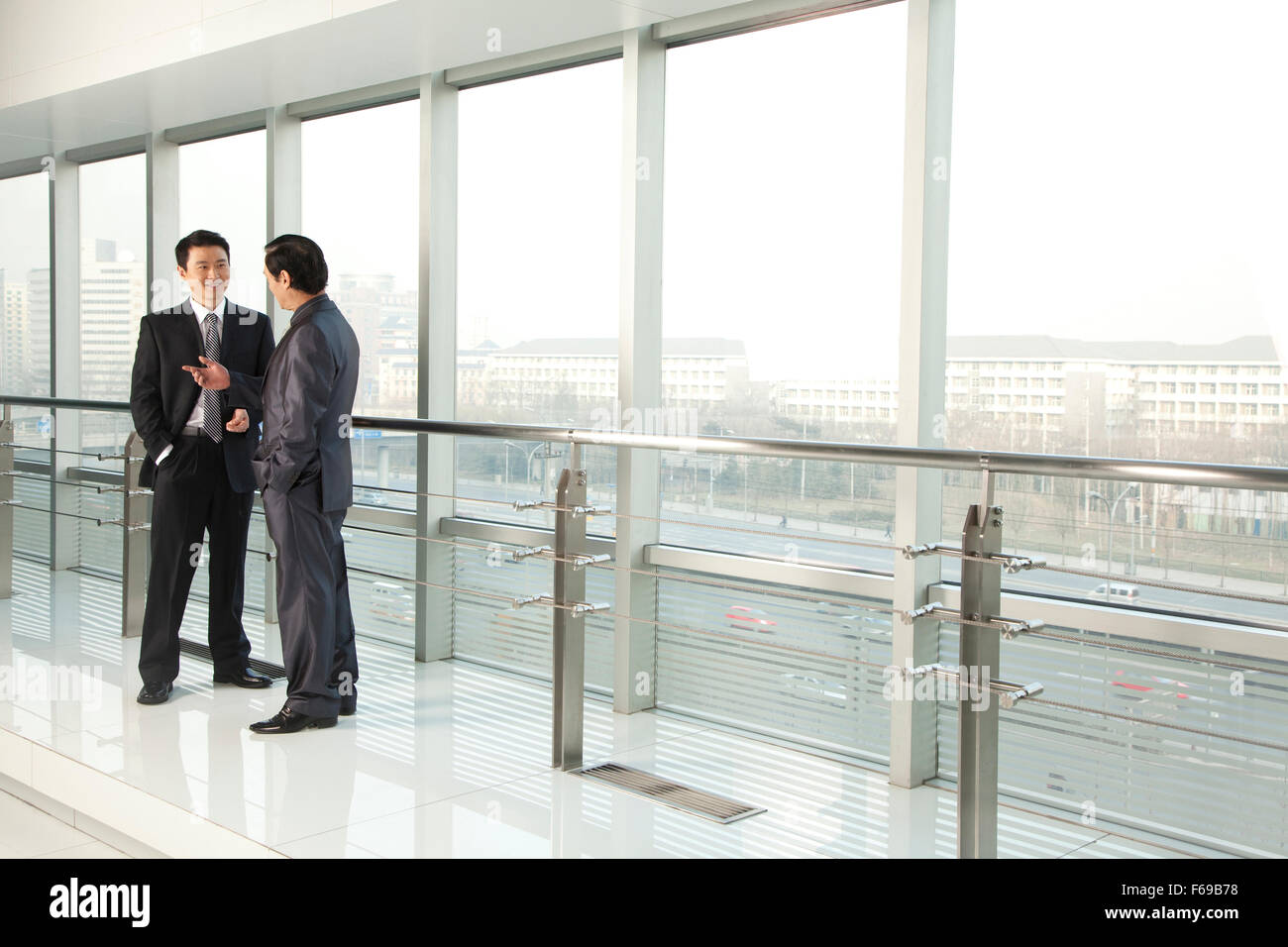 Two Businessmen Talking Stock Photo - Alamy