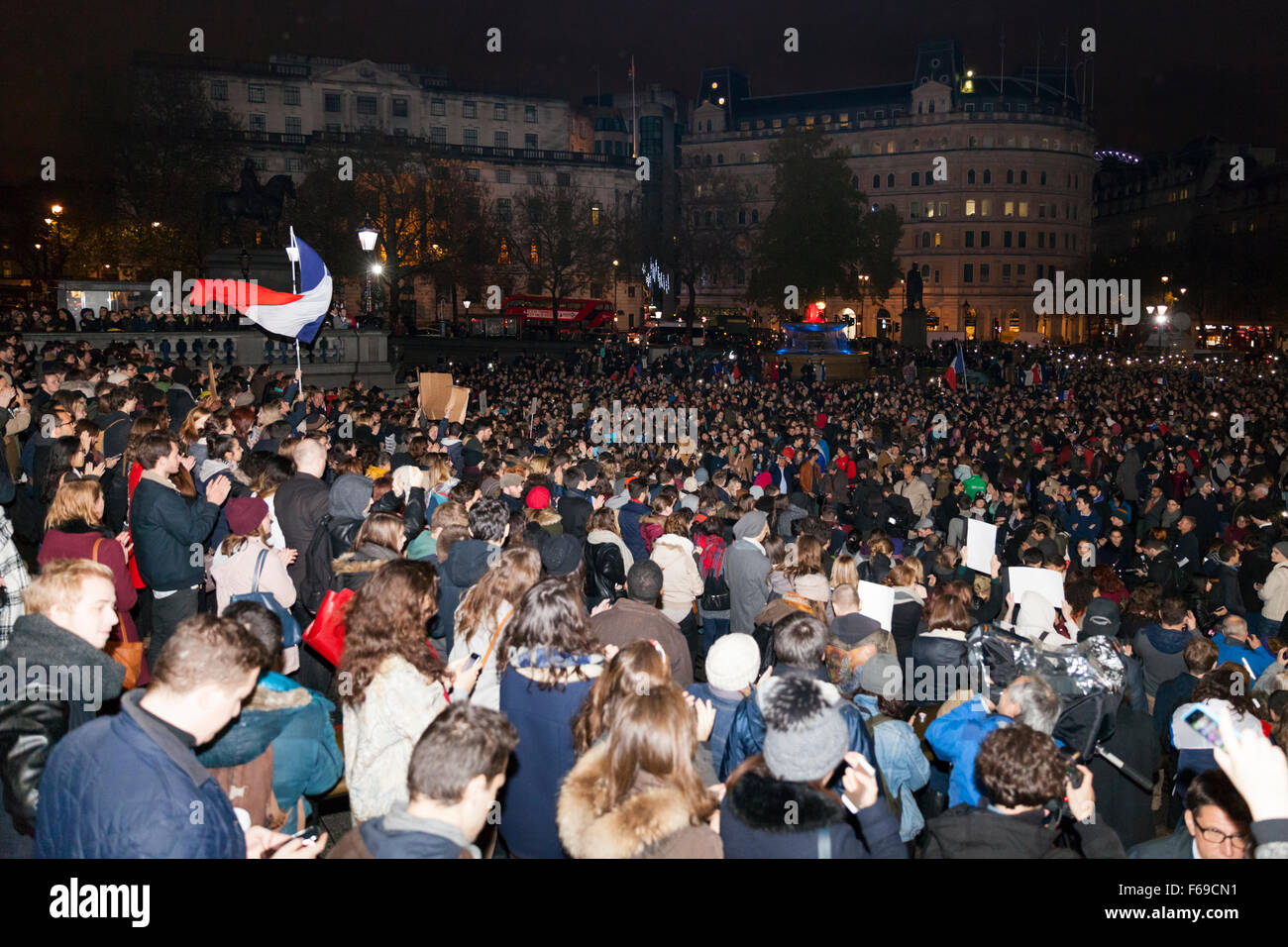 London, Uk. 14th November 2015. Thousands gather in Trafalgar Square to pay their respect to victims in France and show their solidarity in the wake of the Paris attacks. Many join in to sing the Marseillaise and other French songs to applause from the crowd. Stock Photo