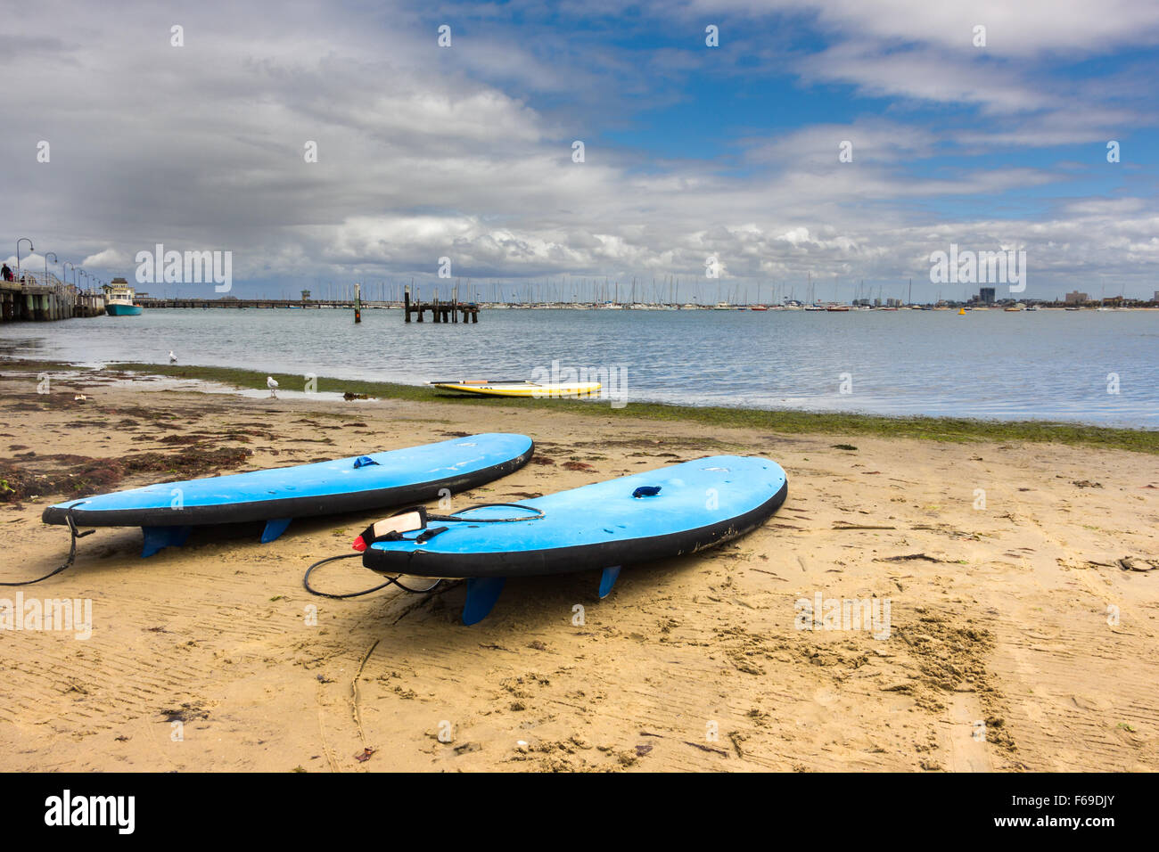 Three surfboards resting on a quiet beach in St Kilda, Melbourne. Stock Photo