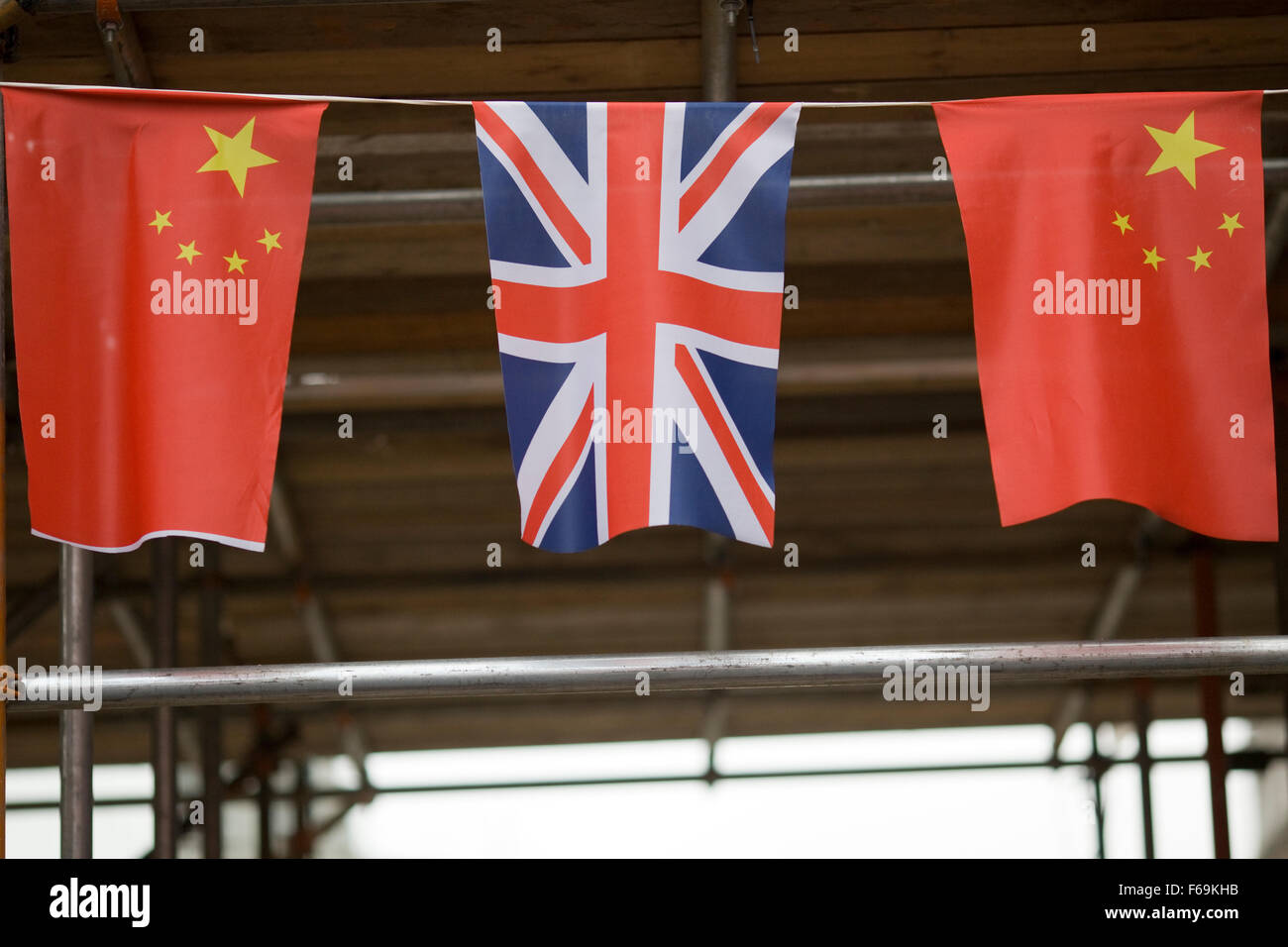 Union Jack bunting and Chinese flag bunting hanging in China Town London Stock Photo