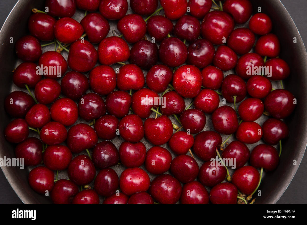 Top view of fresh red cherry in round baking tin Stock Photo
