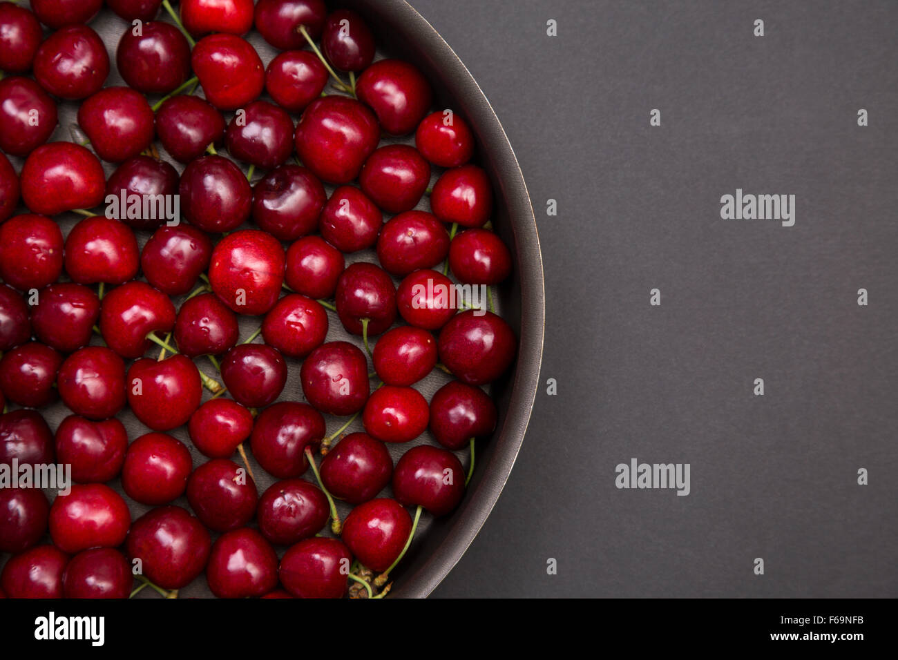 Top view of fresh red cherries in round baking tin, with copy-space for your text Stock Photo