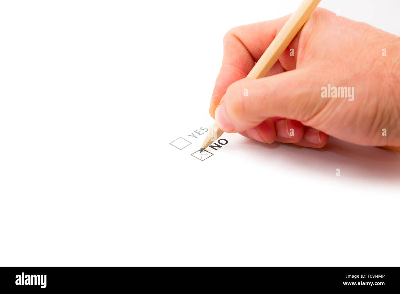 A hand voting in a yes no referendum vote election, they are picking the no option. Stock Photo
