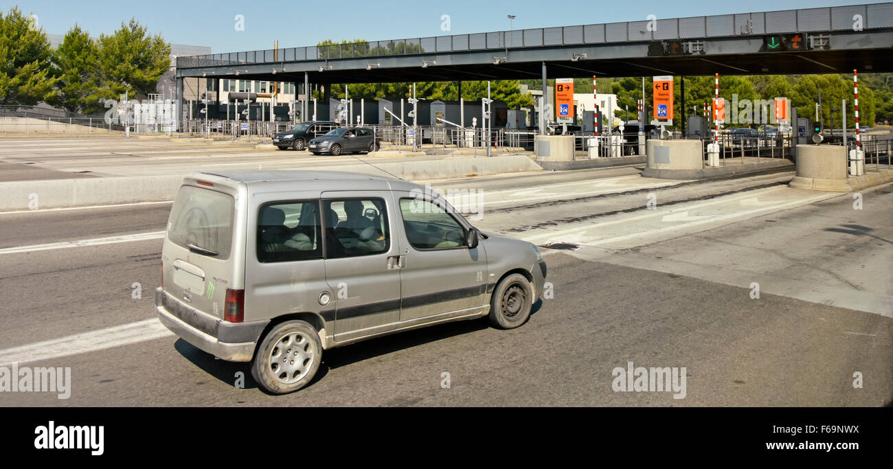 Dirty car approaching toll booths on French motorway autoroute in Provence France obscured number plate Stock Photo