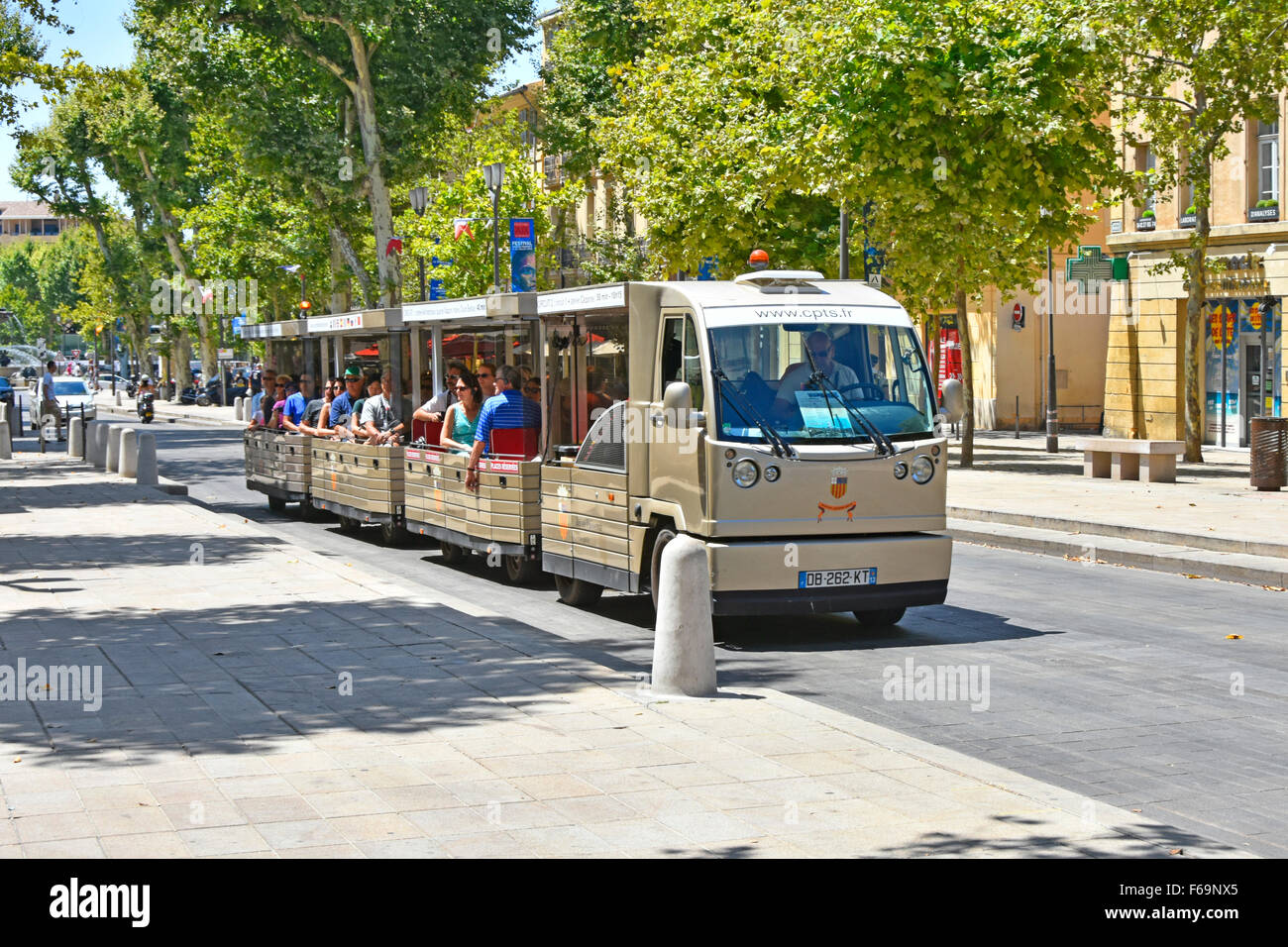 Aix-en-Provence South of France Land train sightseeing trip along the prestigious Cours Mirabeau boulevard on a very hot July day Stock Photo