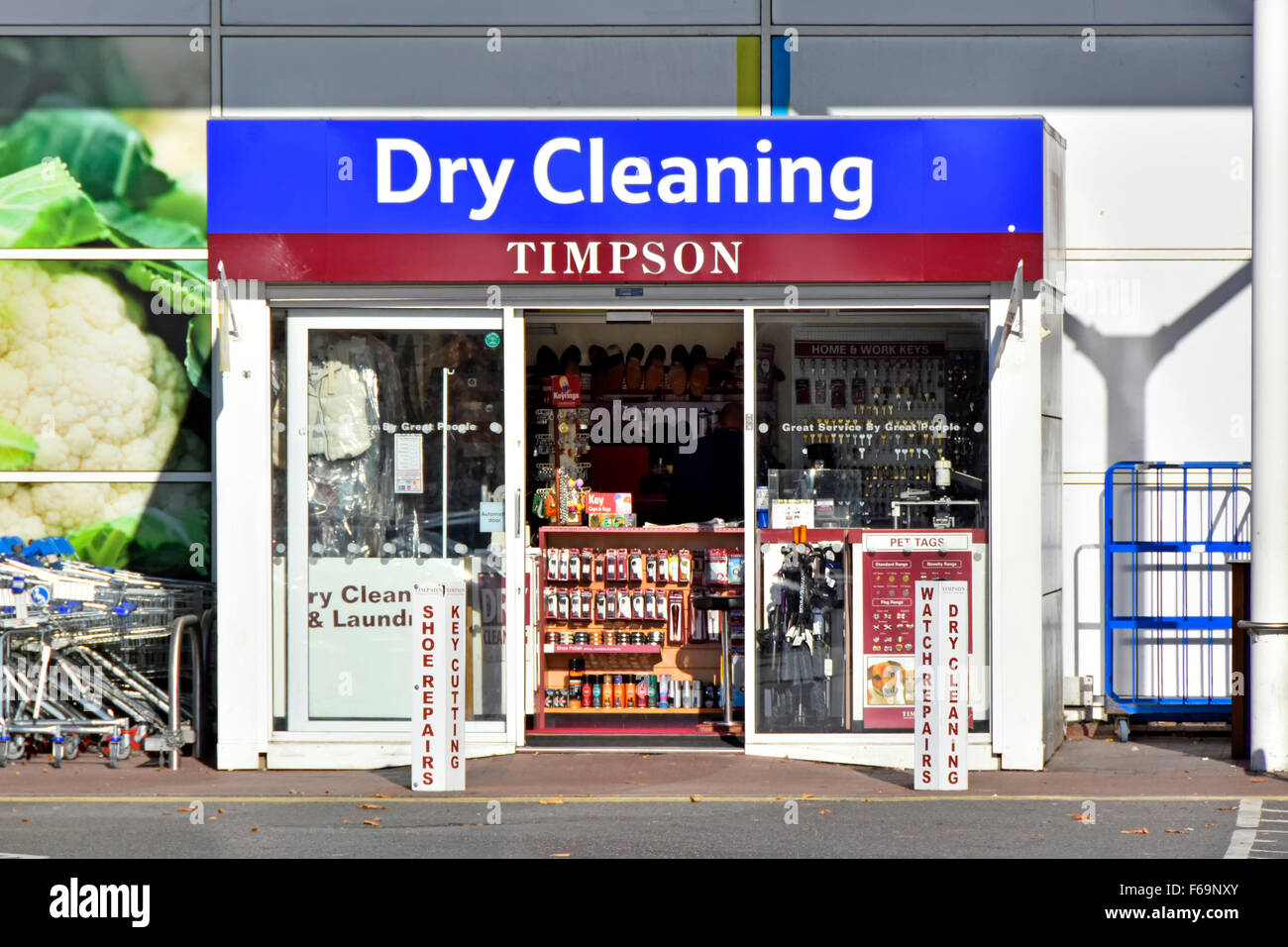 Timpson Dry Cleaning collection and repair kiosk beside main entrance to Tesco Extra supermarket chain store East London England UK Stock Photo