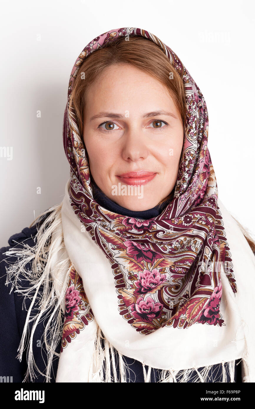 Portrait of smiling Young Caucasian woman in Russian Pavloposadskie scarf on head Stock Photo