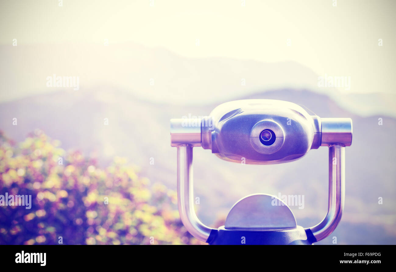 Vintage toned monocular pointed at horizon, shallow depth of field. Stock Photo