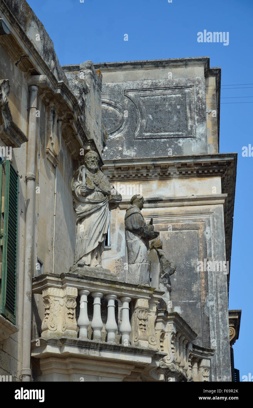 Stone Carvings Man with book in left hand and whip in right hand, Lecce,Italy  Apulia; Puglia; Salentine Peninsula Stock Photo