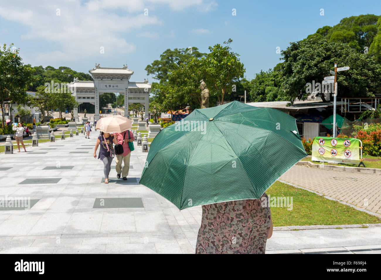 Lady with umbrella at Po Ling monastery in Ngong Ping, Lantau Island, Hong Kong SAR Stock Photo