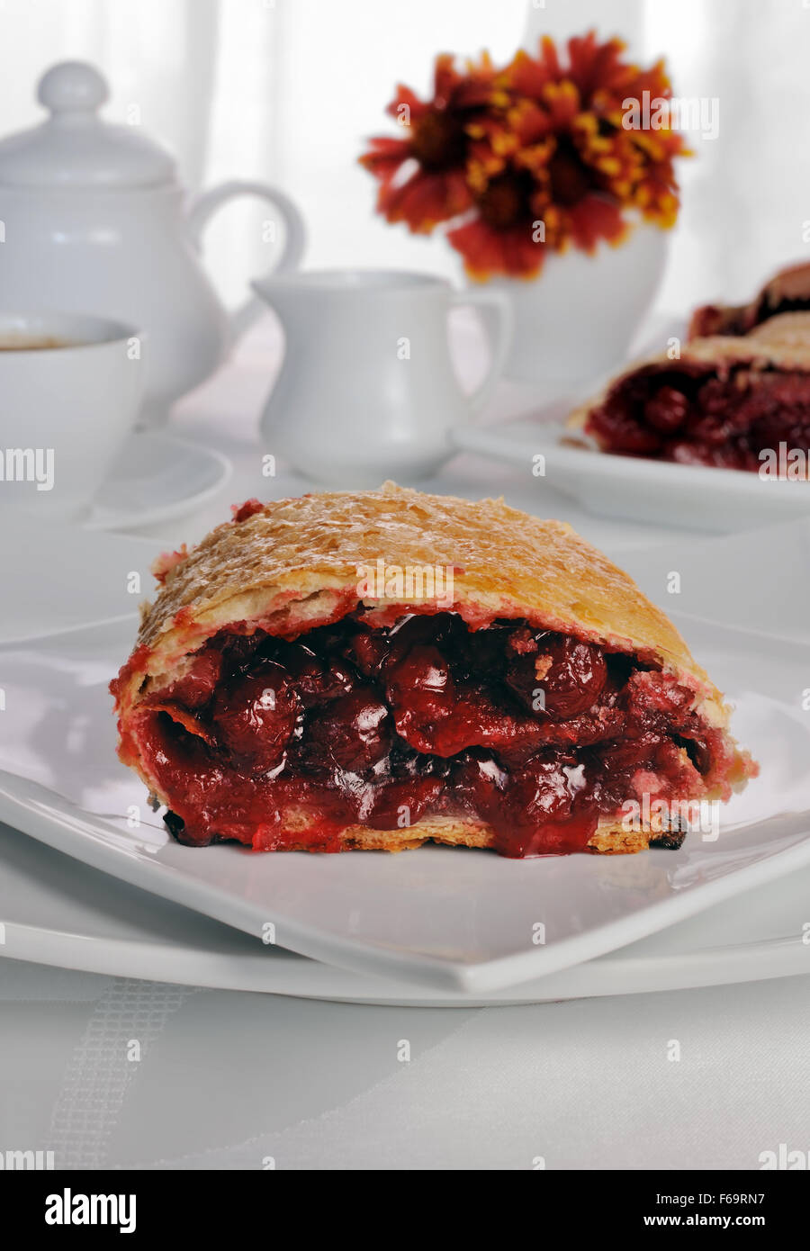 Piece of cherry strudel on the coffee table Stock Photo