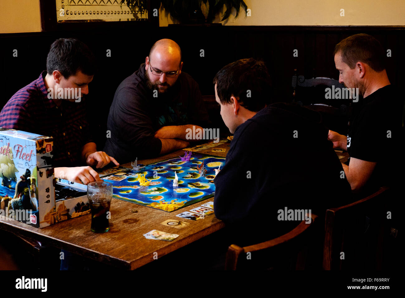 people playing a board game in a traditional pub england uk Stock Photo