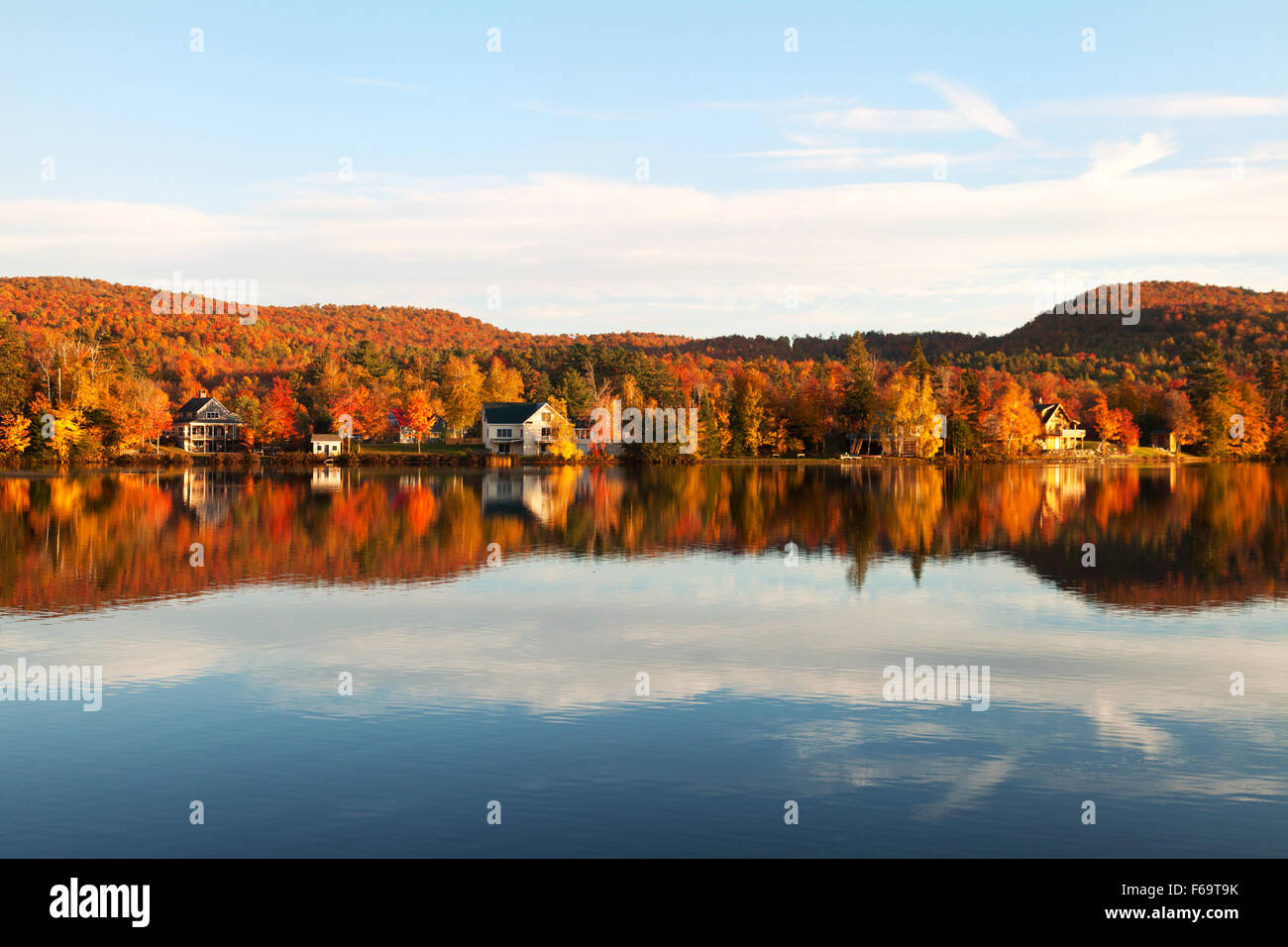 New England in the Fall; Lakeside houses on Eden Lake at autumn sunset
