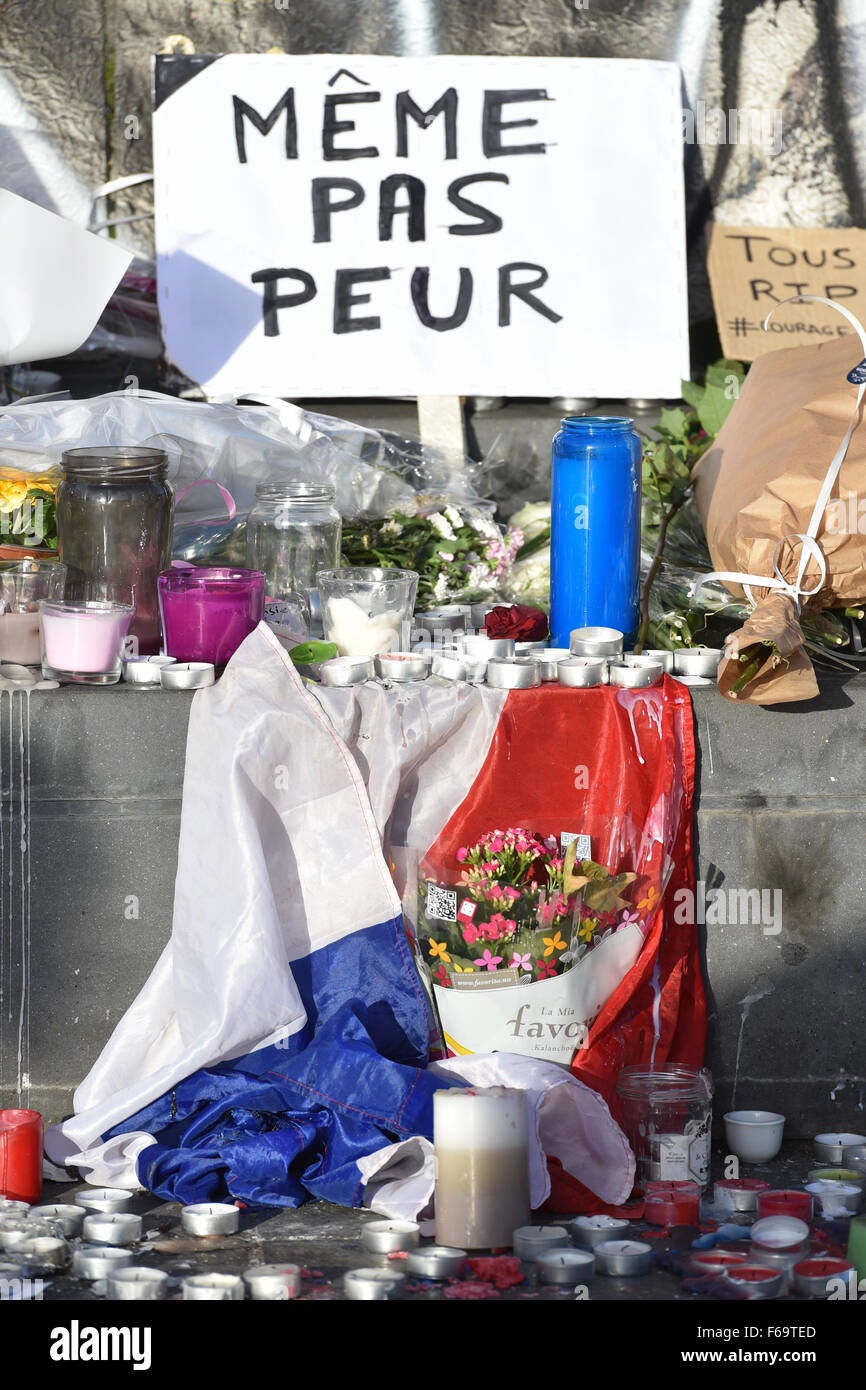 A French flag and a sign that reads "Meme Pas Peur" lays at Place de la  Republique in Paris, France 15 November 2015. At least 129 people were  killed in a series
