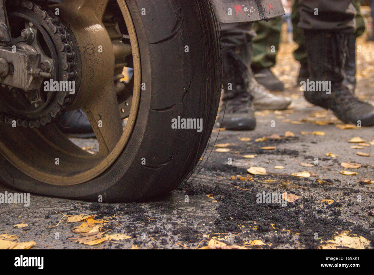 Motorcycle burned tire on the pavement and motorcyclists Stock Photo
