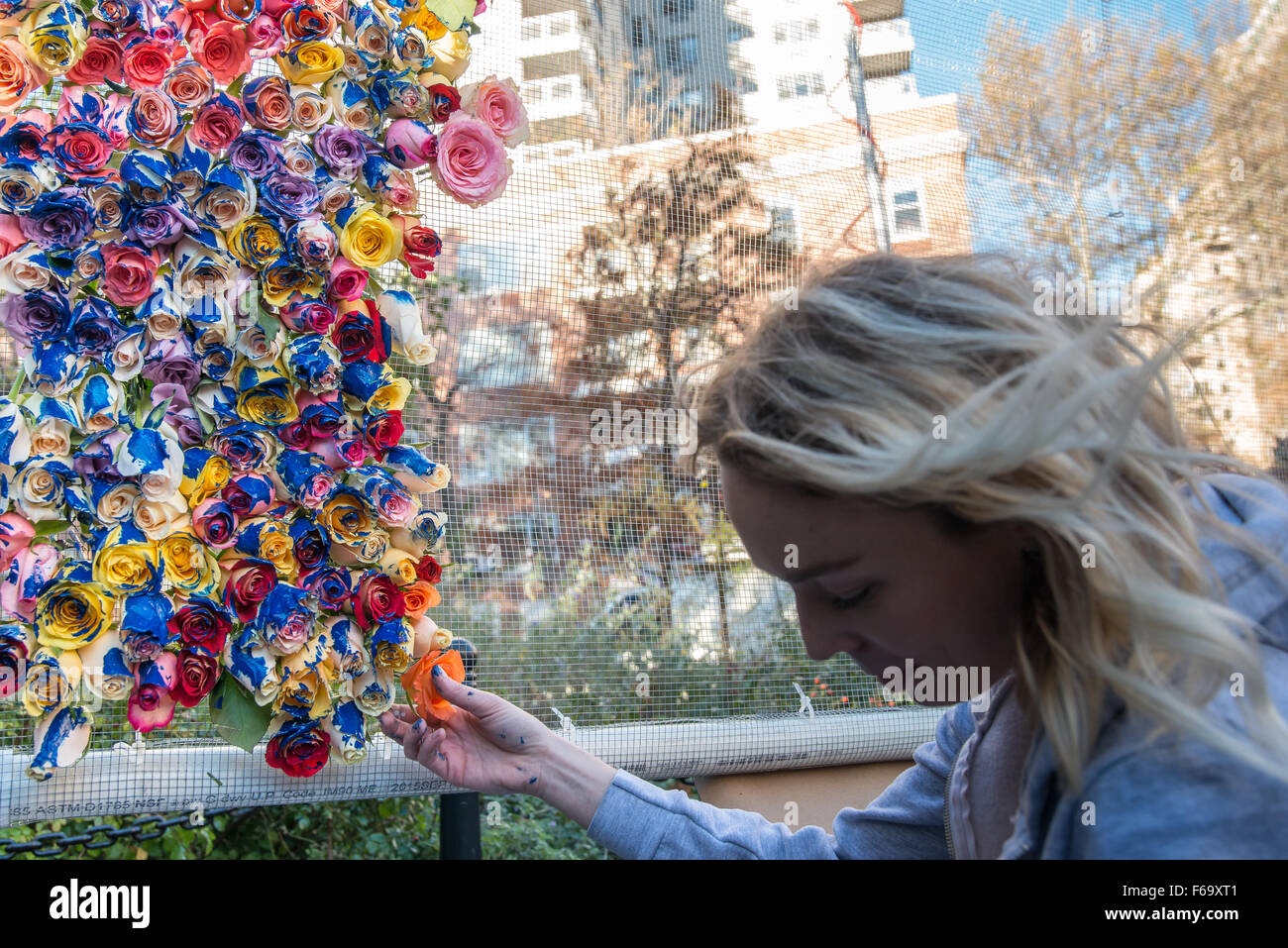New York, United States. 14th Nov, 2015. A artist at the mass vigil in Washington Square Park assembles an hommage to the Paris attack victims made of flowers dipped in paint. Around New York City residents and elected officials reacted individually and collectively to express their grief over the terrorist attacks in Paris that claimed over 100 lives and left hundreds wounded. Credit:  Albin Lohr-Jones/Pacific Press/Alamy Live News Stock Photo