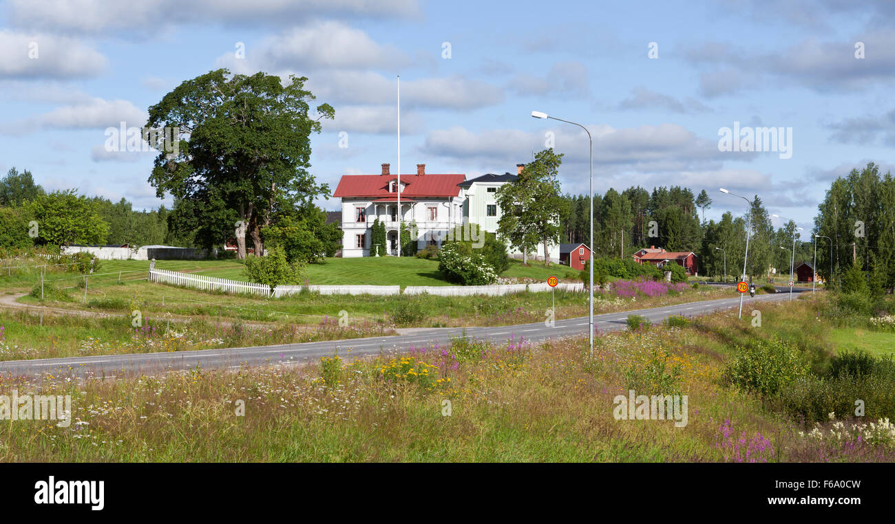 HALSINGLAND, SWEDEN ON JULY 24, 2015. View of a beautiful wooden homestead, buildings. Garden, park, and highway. Editorial use. Stock Photo