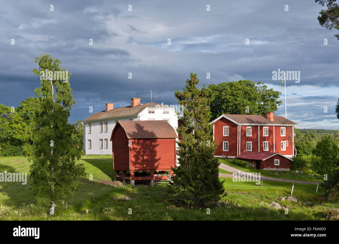HALSINGLAND, SWEDEN ON JULY 23, 2015. View of a beautiful wooden homestead. Falu Red Paint colors and farmland. Editorial use. Stock Photo