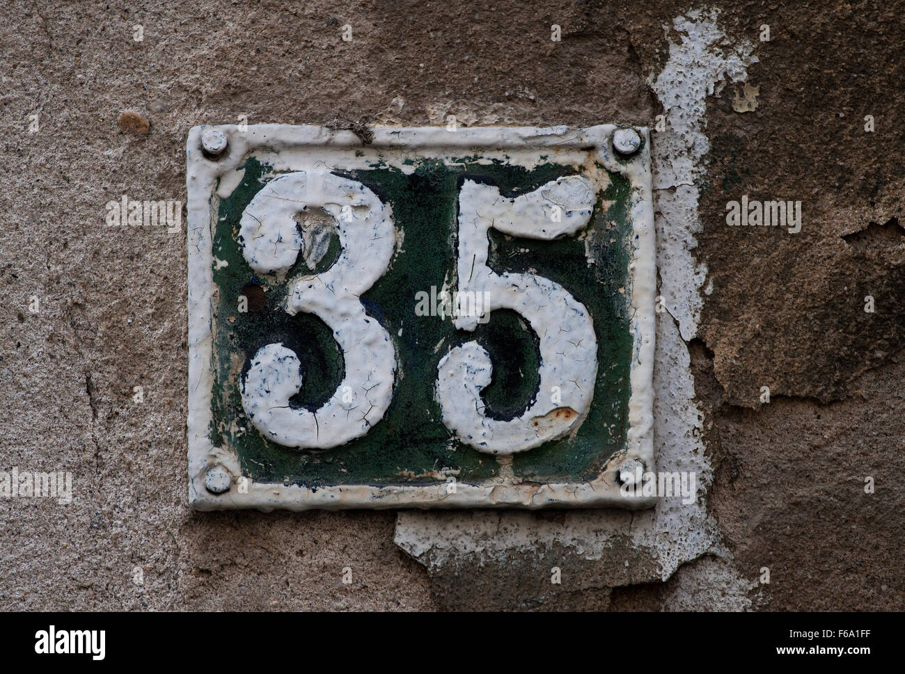 Vintage metal house number on the wall, retro house number Stock Photo