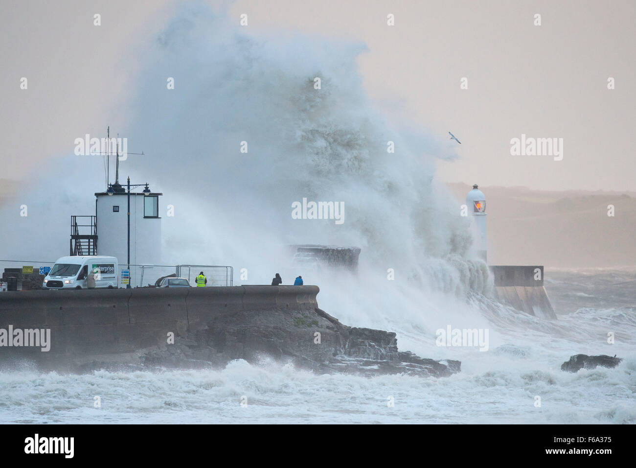 Strong winds cause huge waves crash over the lighthouse at Porthcawl seafront, South Wales, as Storm Barney arrives. Stock Photo